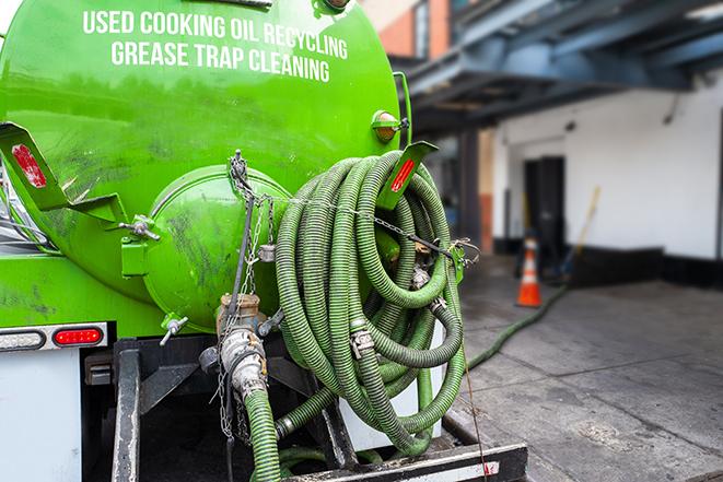 maintenance crew pumping grease trap at a fast food restaurant in Allston, MA